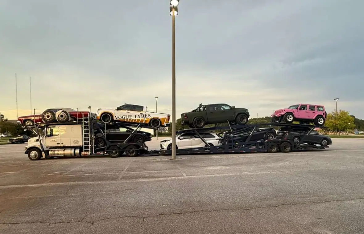A car hauler loaded with a full lineup of vehicles
